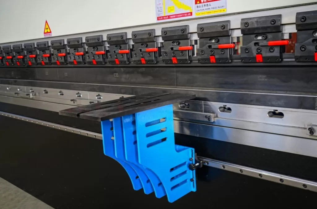 a blue plastic pieces on a metal machine