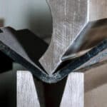 a metal piece of metal with a black rubber strip