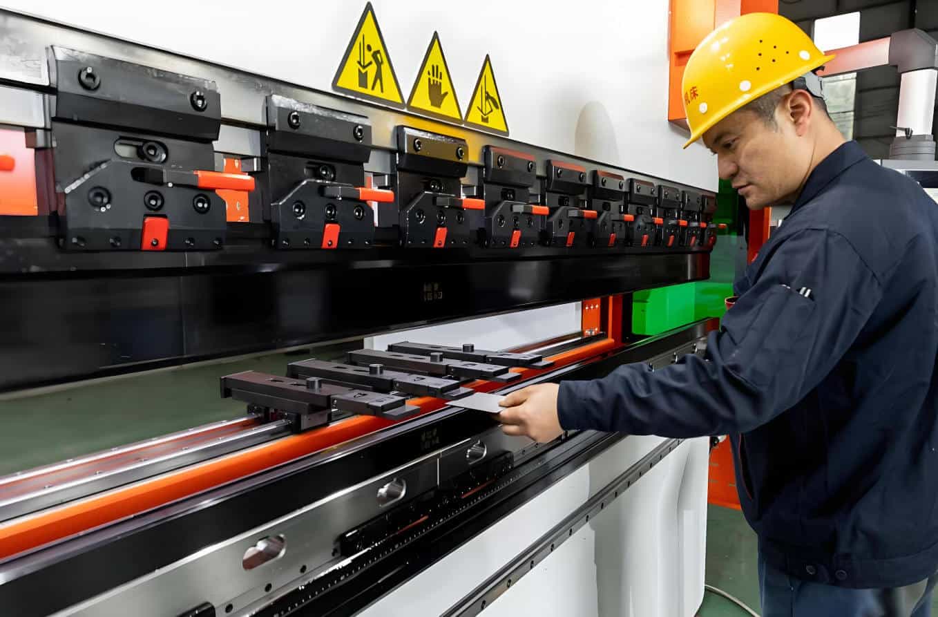 Operator is manually operating a press brake to test samples
